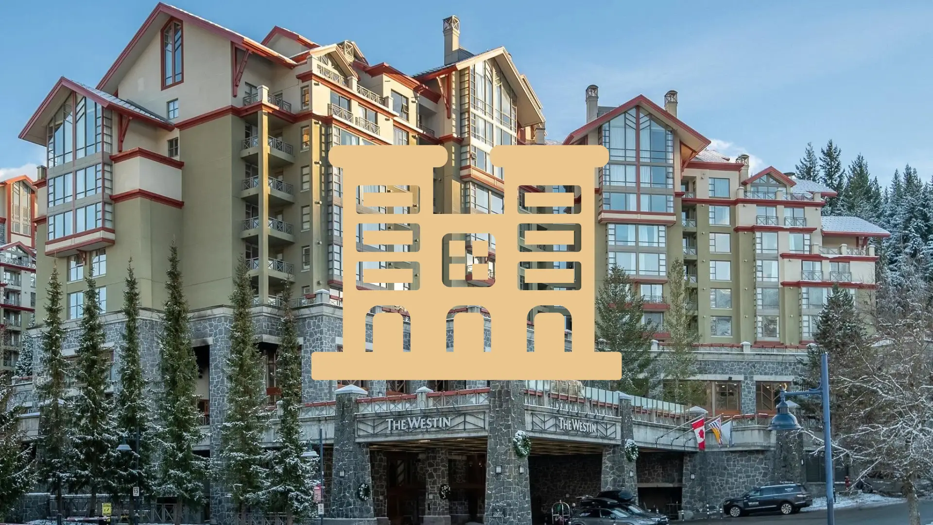 A whistler condo building surrounded by snow topped trees